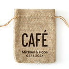 Personalized burlap drawstring favor bag printed with “CAFÉ,” names, and a date